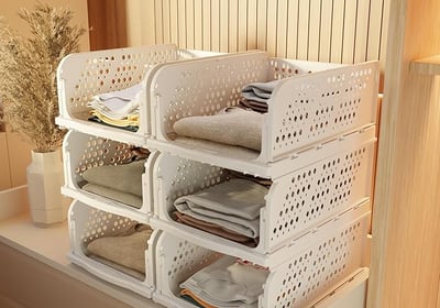 a stack of white plastic containers with towels and towels