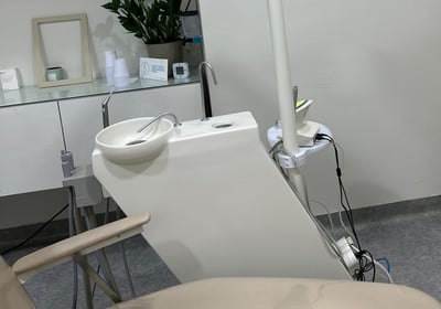 a dental room with a chair and a chair