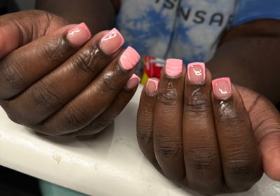 a woman with pink nails and pink manicures