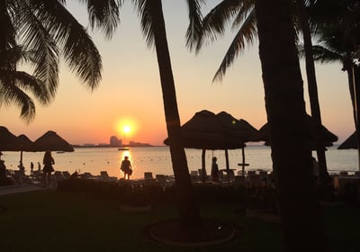 a person standing in front of a sunset