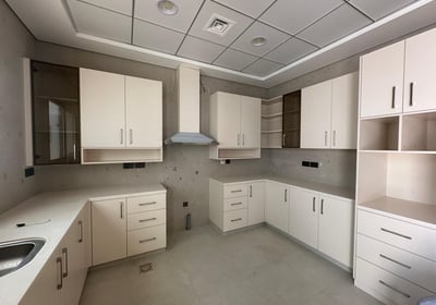 a kitchen with white cabinets and white cabinets