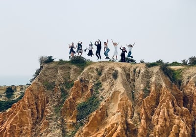 Adventure travelers exploring the Seven Hanging Valleys Trail with ocean views in southern Portugal
