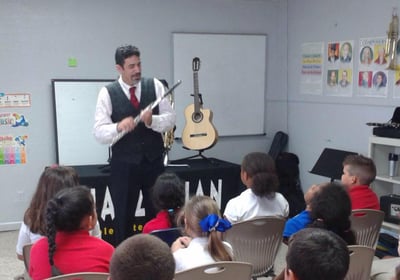Maestro Bobby Ramirez teaching kids about the flute