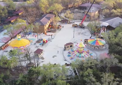 a large area with a large amount of people and a ferris wheel