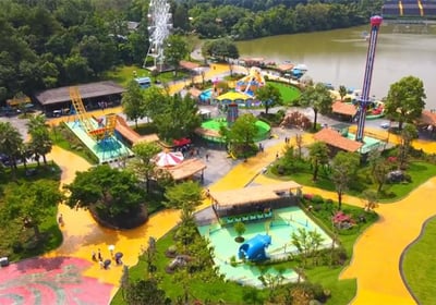 a park with a ferris wheel and a ferris wheel