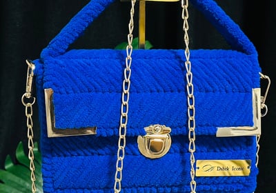 a blue purse with chain link and chain link