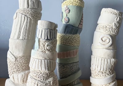 a group of ceramic sculptures vases