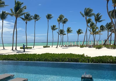 Beach with palm trees and white sand beach and pool