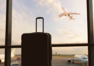 a suitcase and a suitcase in front of a window