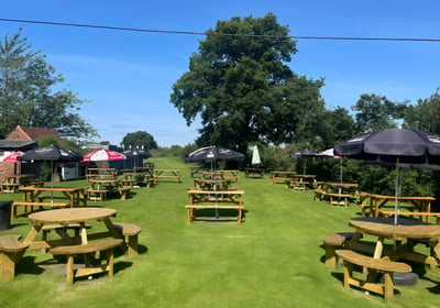 a beer garden with umbrellas and umbrellas