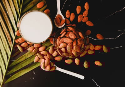 a glass of milk with almonds and almonds