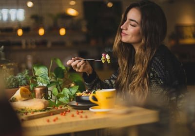 a woman is eating a meal in a restaurant