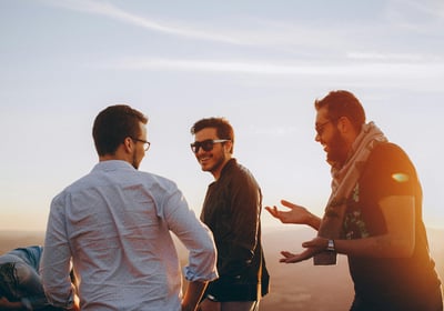 a group of men standing around a table