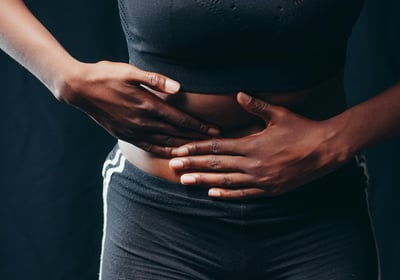a woman with her hands on her stomach
