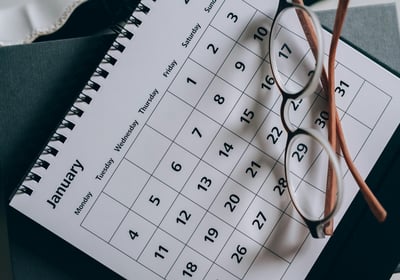 a calendar calendar with a pair of glasses and a pair of eyeglasses