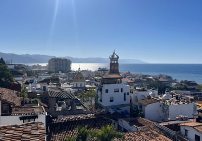a view of a city with a clock tower in the background