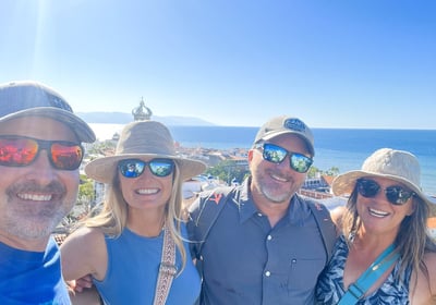 a group of people standing around a man in a hat