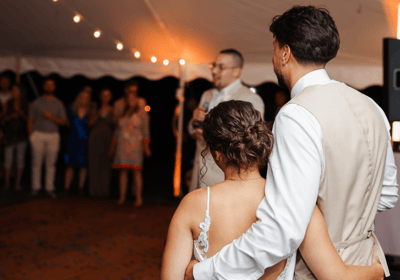 Couple holding each other during wedding toast