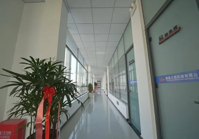 Zorulift Construction Machinery: Bright, modern office corridor to Manufacturing Dept. Clean, professional.