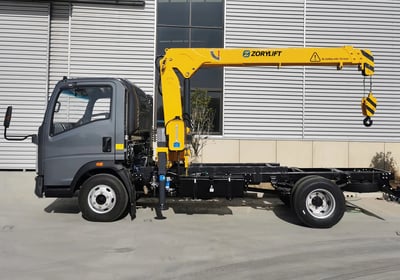 Zorylift straight arm truck crane (truck-mounted crane) in yellow, on a commercial vehicle, outrigger deployed.