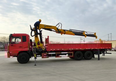 Yellow Zorylift SQZ350A.4 16T knuckle boom crane on red truck operated by worker. Heavy duty, truck/lorry mounted.