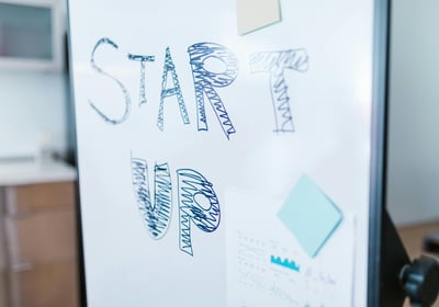 A business whiteboard with the words 'Start Up' on it