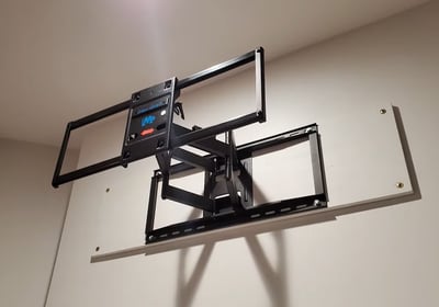 A TV mounting over a a board for better grip to the wall