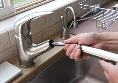Removing the nut from the faucet for replacement
