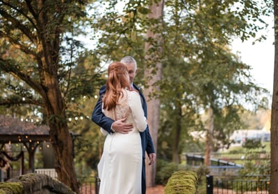 Husband and wife photographed in a forest on their wedding day