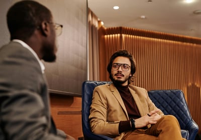 Two men are talking business in a hotel lobby