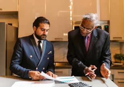 Two men are talking business in kitchen