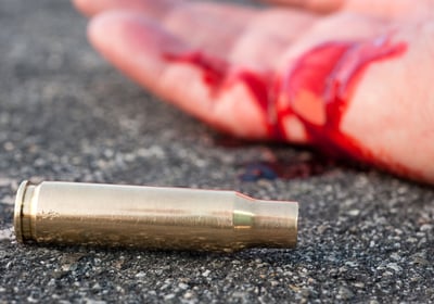 wounded person laying on the street after deadly force used