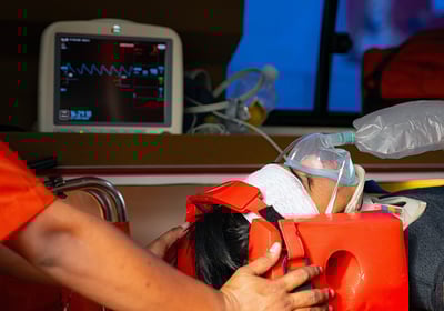 Injured teen, boarded in an ambulance receiving air by hand