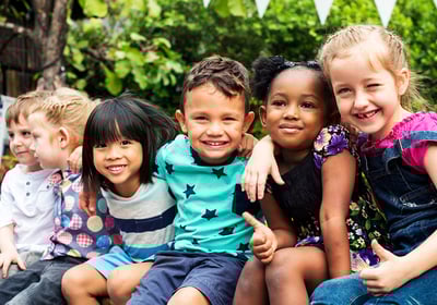 multi-racial children anging out laghing and playing.