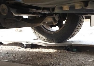 a car that is sitting on a broken tile that has been treated with SafePave