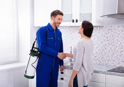 a professional pesticider worker shaking hands with a pesticider