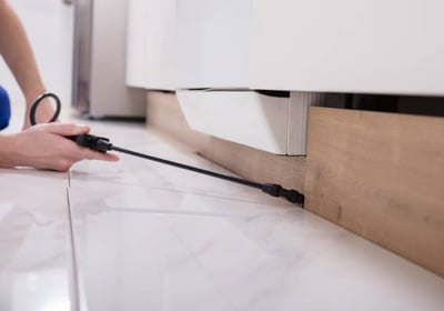 a person is using a cord cordless device to remove a kitchen floor
