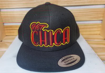 Black snapback hat with bold red and yellow Hot Chica embroidery – custom streetwear cap by Stitch &