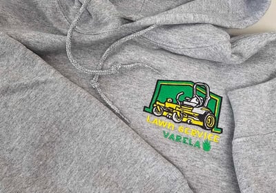Gray hoodie with custom embroidered Lawn Service Varela logo featuring yellow lawn mower – business