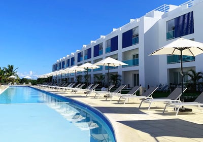 a pool with lounge chairs and umbrellas