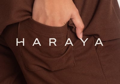 a person wearing a brown sweater and a brown pantsuitt