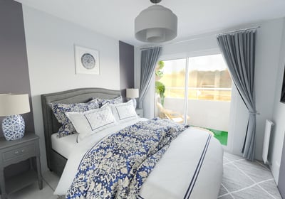 a bedroom with a bed and a lamp