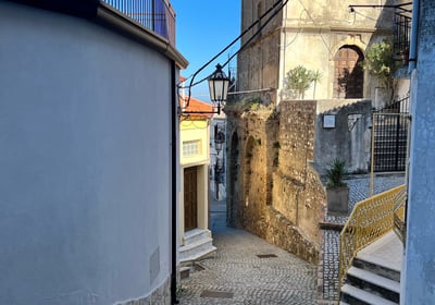 a narrow alleyway with stairs and a staircase