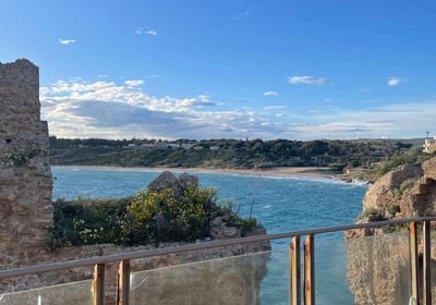 a balcony with a balcony and a view of the ocean
