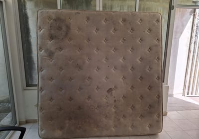 a mattress topper in a room with a chair and a chair