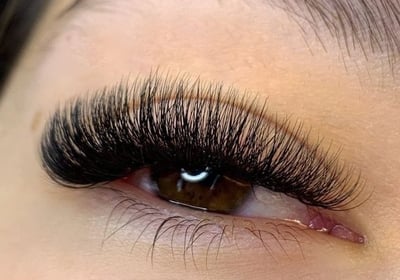 a woman with a long, black eyeliners and a pair of lashes