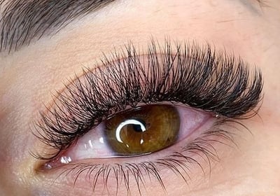 a woman with a large eyeliners and a pair of lashes