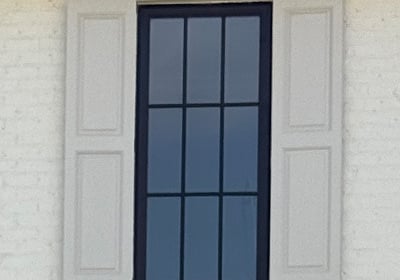 Fixed exterior shutters on a brick home