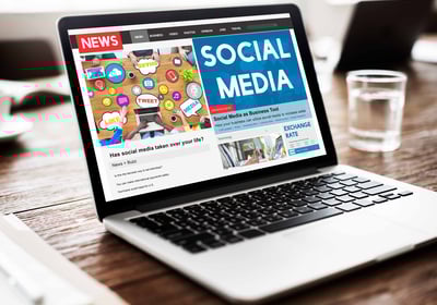 a laptop computer screen displaying a social media page on a news page