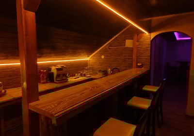 a bar with stools and stools in a room